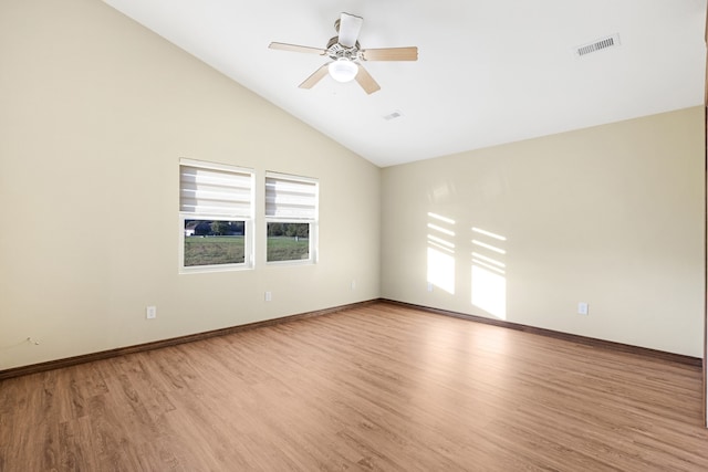 empty room featuring light wood-type flooring, high vaulted ceiling, and ceiling fan