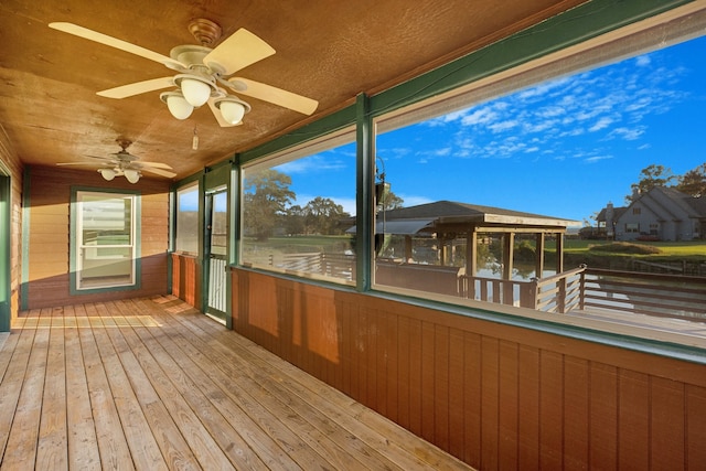 unfurnished sunroom with ceiling fan and a healthy amount of sunlight