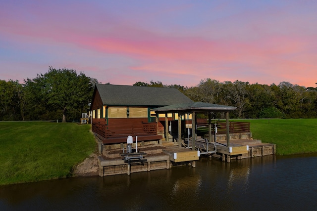 dock area featuring a lawn and a water view