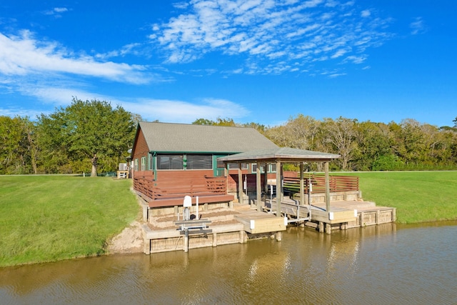 view of dock with a yard and a water view