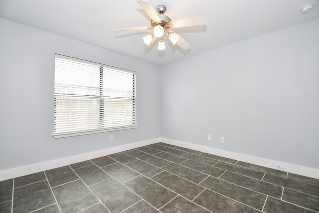 unfurnished bedroom featuring a closet, dark tile patterned floors, and ceiling fan