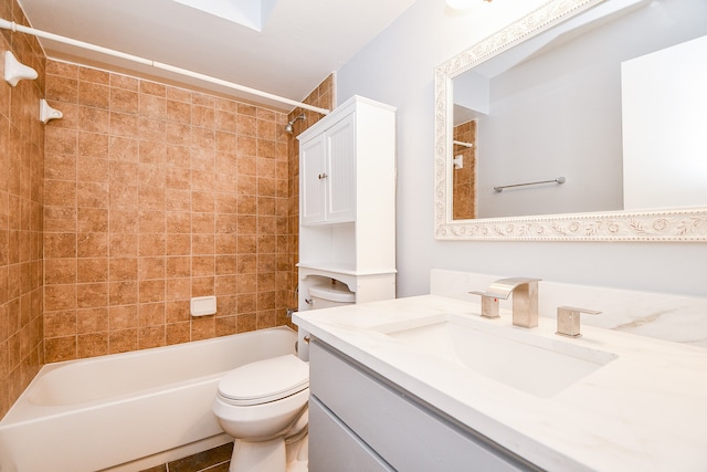 full bathroom featuring tile patterned flooring, vanity, toilet, and tiled shower / bath