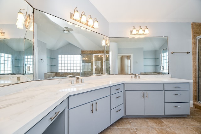 bathroom with tile patterned floors, vanity, an enclosed shower, and lofted ceiling