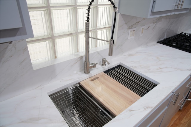 room details with decorative backsplash and light stone counters