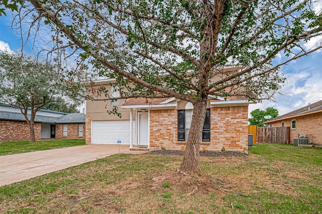 view of front of house featuring central AC, a garage, and a front lawn