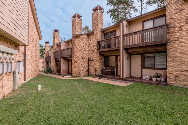 rear view of property with a lawn