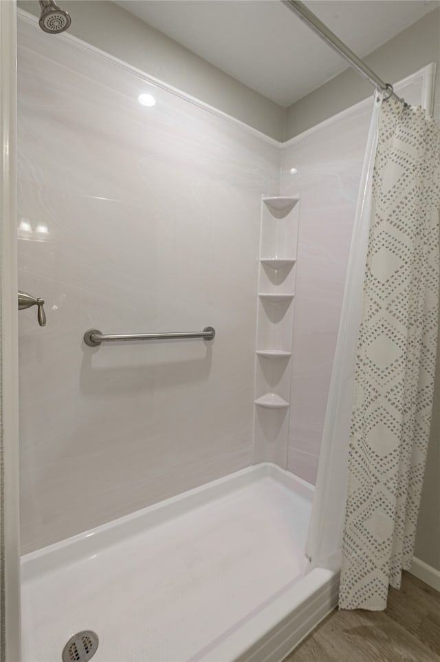 bathroom with hardwood / wood-style floors and a shower with curtain