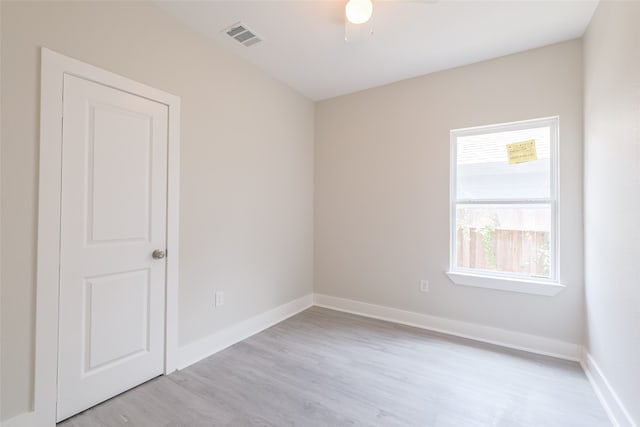 spare room featuring light wood-type flooring and ceiling fan