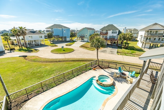 view of pool with a lawn, a fire pit, and a patio