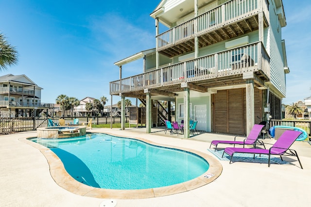 view of swimming pool with a patio and a hot tub