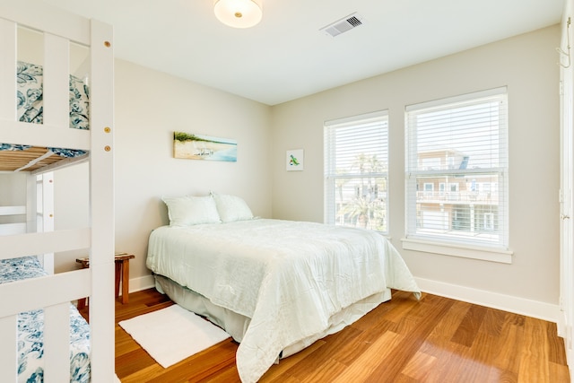 bedroom featuring wood-type flooring and multiple windows