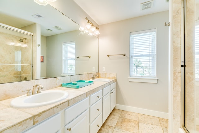 bathroom featuring plenty of natural light, walk in shower, and vanity