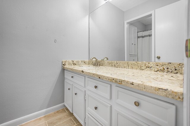 bathroom with vanity and curtained shower