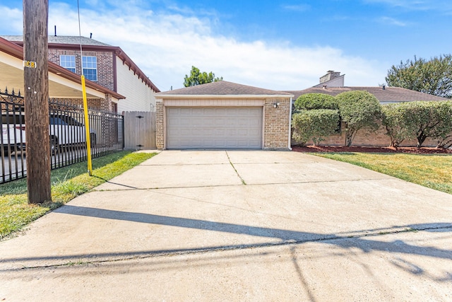 view of front of home with a garage and a front yard