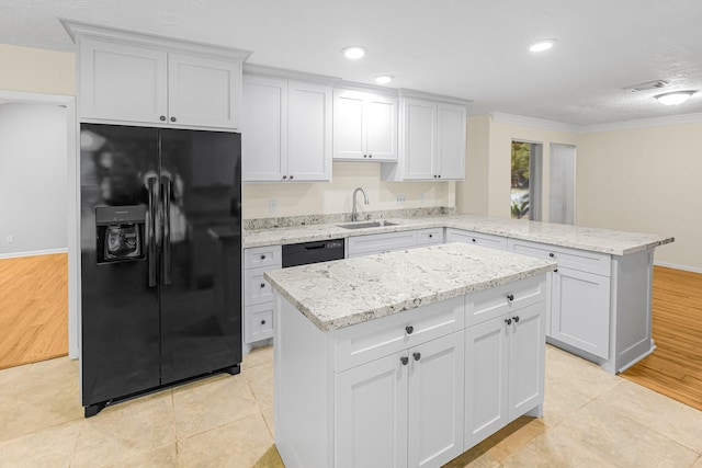 kitchen featuring white cabinetry, a center island, sink, and black appliances