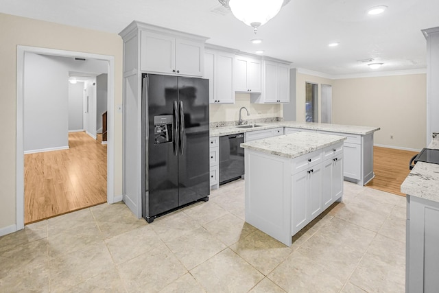 kitchen featuring sink, a center island, ornamental molding, black appliances, and kitchen peninsula