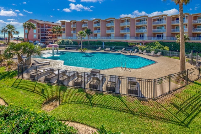 view of pool with a patio and pool water feature