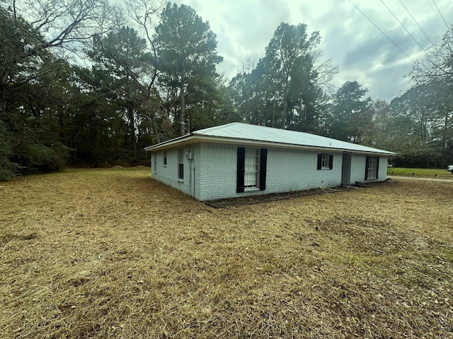 rear view of house featuring a lawn