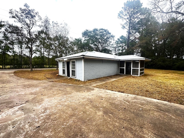 view of property exterior with a sunroom