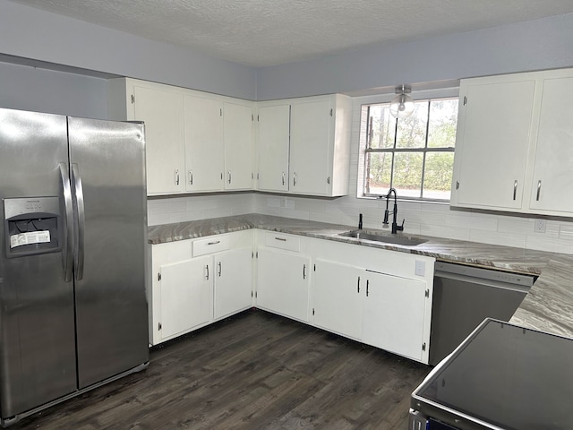 kitchen with dark hardwood / wood-style flooring, sink, white cabinetry, and stainless steel appliances