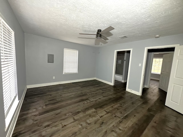 unfurnished bedroom featuring a textured ceiling, ceiling fan, and dark hardwood / wood-style floors