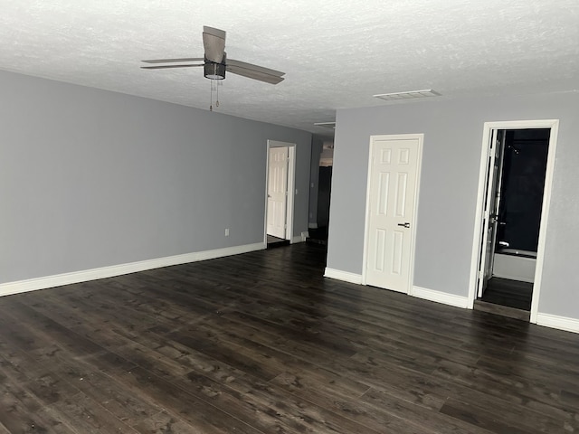 spare room with ceiling fan, dark wood-type flooring, and a textured ceiling