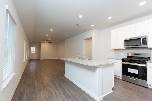 kitchen with ceiling fan, white cabinetry, sink, an island with sink, and appliances with stainless steel finishes