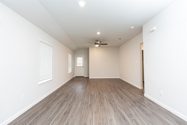 spare room featuring ceiling fan, vaulted ceiling, and hardwood / wood-style flooring