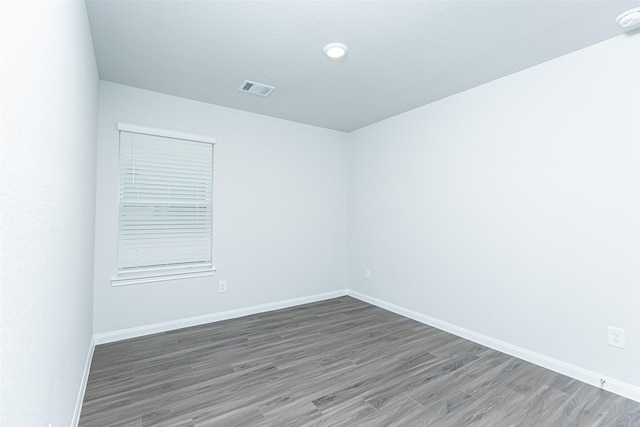 spare room featuring dark hardwood / wood-style floors