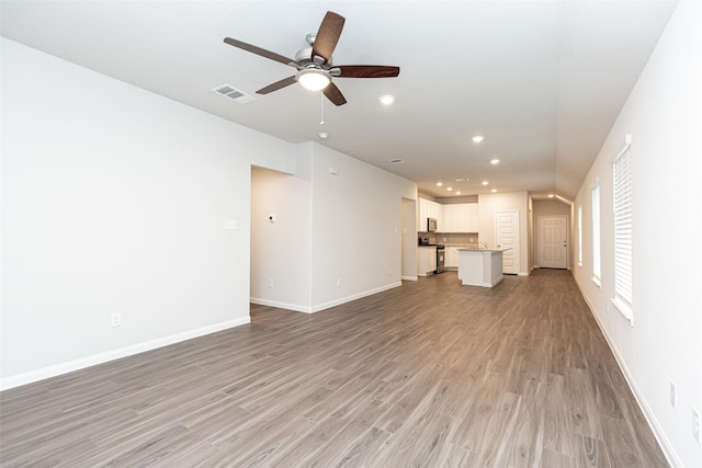 unfurnished living room with ceiling fan and light hardwood / wood-style floors