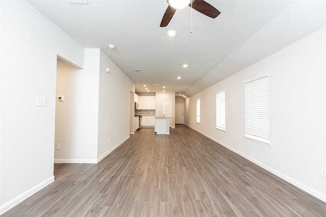 unfurnished living room with ceiling fan and light hardwood / wood-style floors