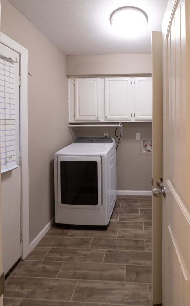 laundry room with cabinets, washer / clothes dryer, and dark wood-type flooring