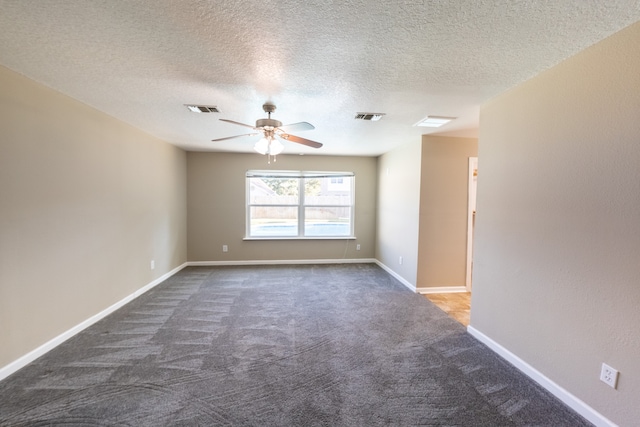 carpeted spare room featuring ceiling fan and a textured ceiling