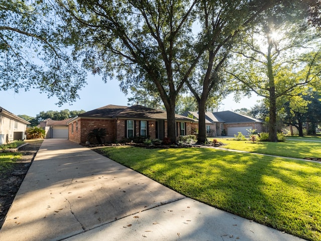 ranch-style house with a garage and a front lawn