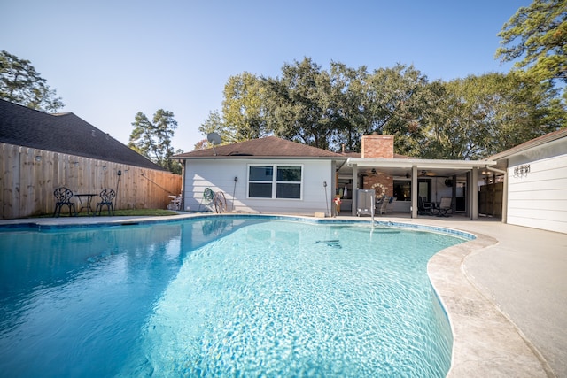 view of pool with ceiling fan and a patio area