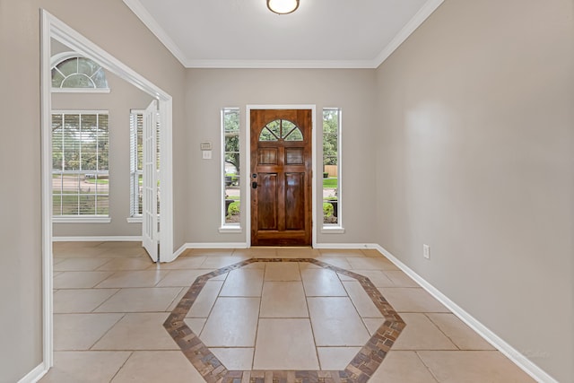 tiled foyer with a healthy amount of sunlight and crown molding