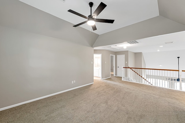 carpeted empty room featuring ceiling fan and lofted ceiling