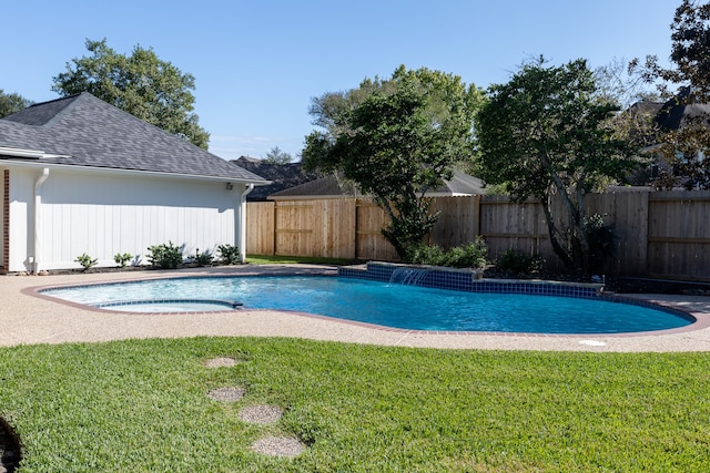 view of swimming pool with pool water feature and a lawn