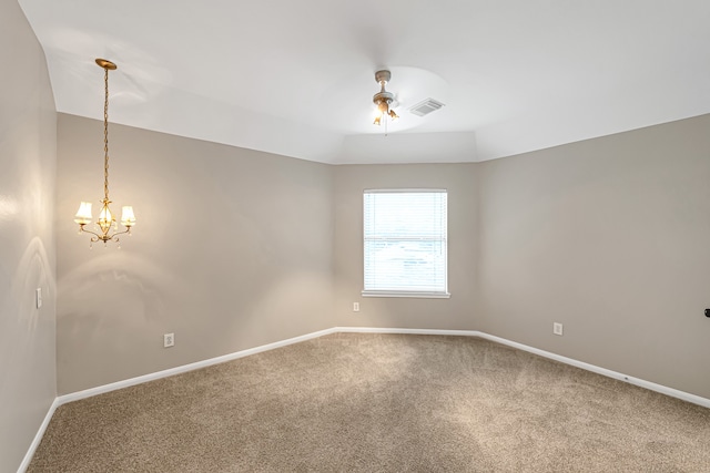 carpeted empty room with a notable chandelier