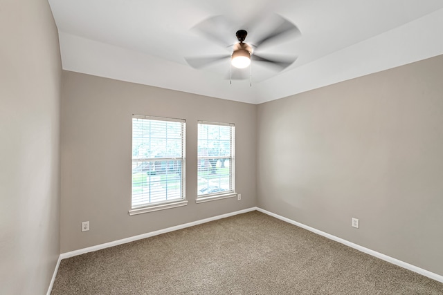 carpeted empty room featuring ceiling fan