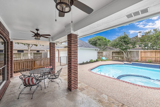 view of swimming pool featuring an in ground hot tub and a patio