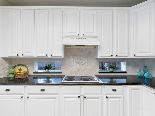 kitchen with white cabinets, custom exhaust hood, decorative backsplash, and electric cooktop