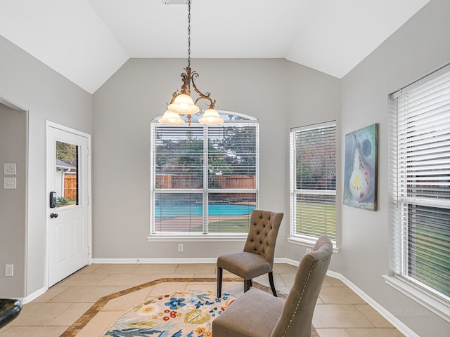 sitting room with light tile patterned floors, a chandelier, and vaulted ceiling