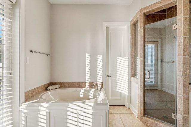 bathroom featuring tile patterned floors and separate shower and tub