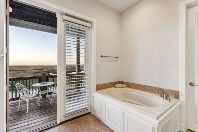 bathroom featuring tile patterned floors and a bathtub