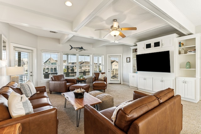 living room featuring beamed ceiling, ceiling fan, and light colored carpet