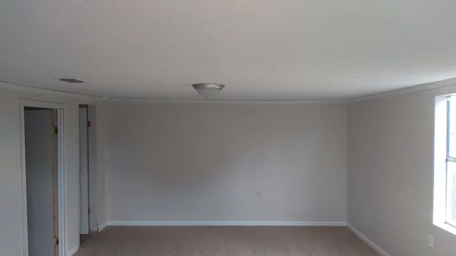 unfurnished room with carpet flooring, a textured ceiling, and crown molding