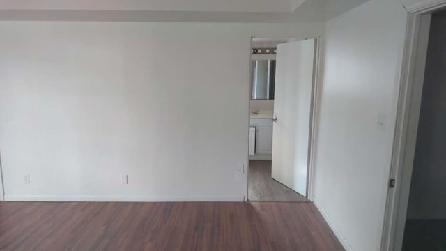 spare room with dark wood-type flooring