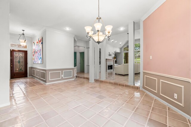 interior space featuring an inviting chandelier, crown molding, and light tile patterned flooring