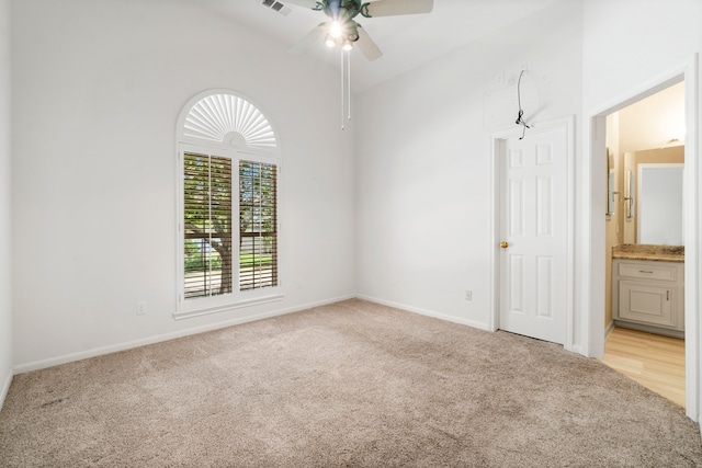 carpeted spare room with ceiling fan